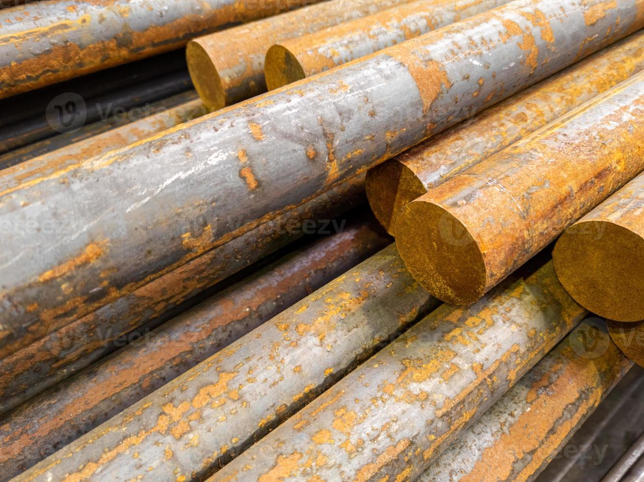 rusted long round steel bars pack - close-up with selective focus photo