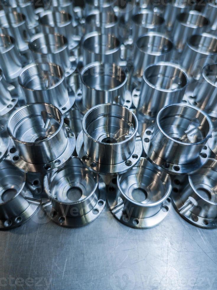 a large batch of shiny metal cnc aerospace parts - close-up with selective focus for industrial manufacturing background photo