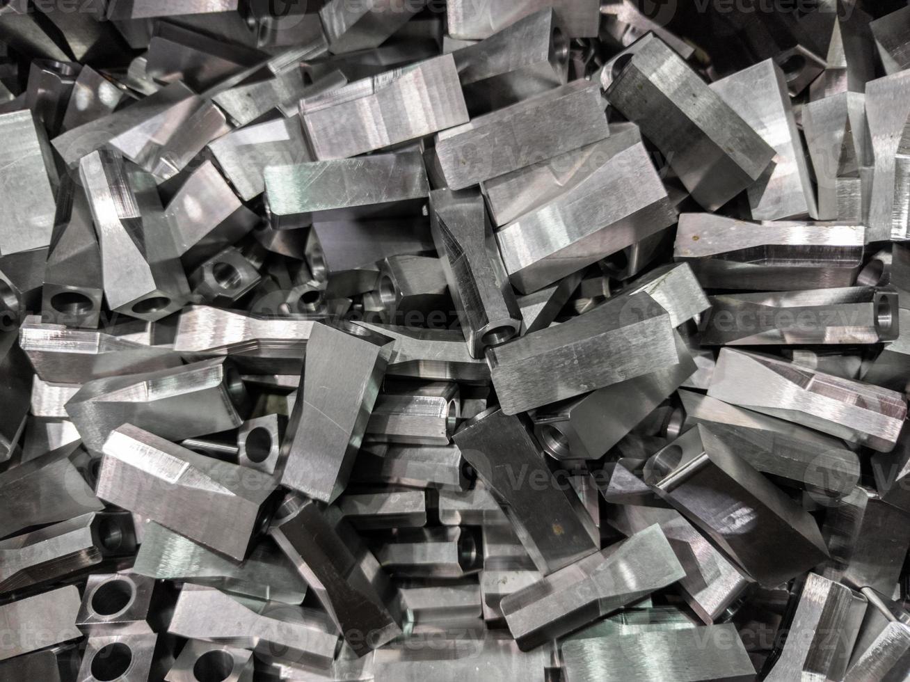 full frame industrial background of pile of shiny steel flat grinded parts photo