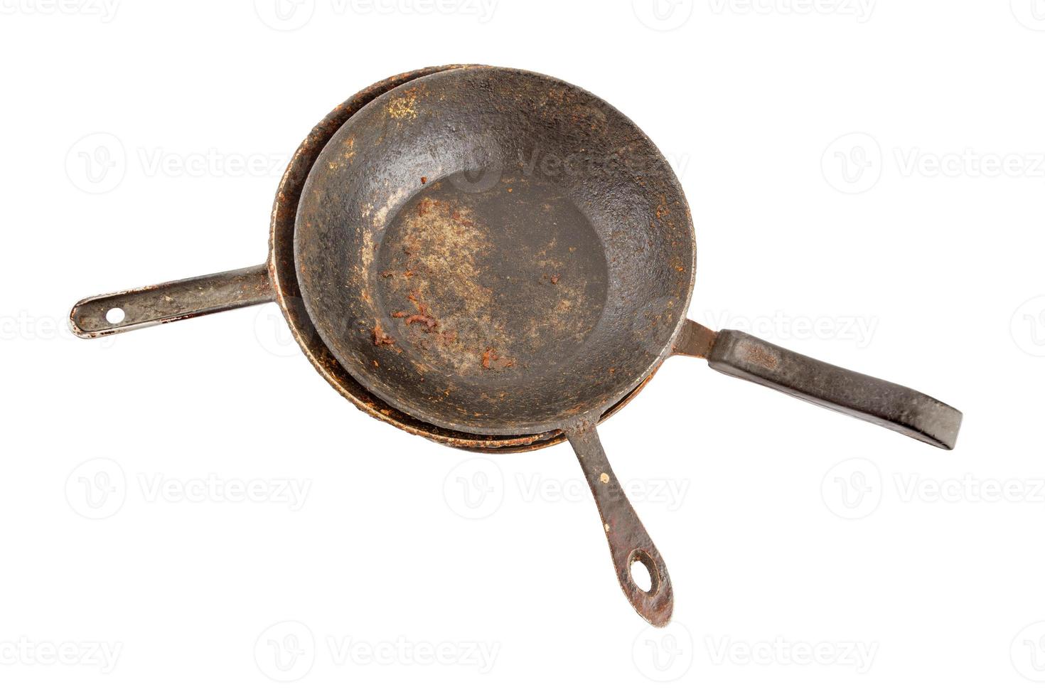 old disgusting stained rusty cast iron pan stack with burnt fat and food leftovers isolated photo