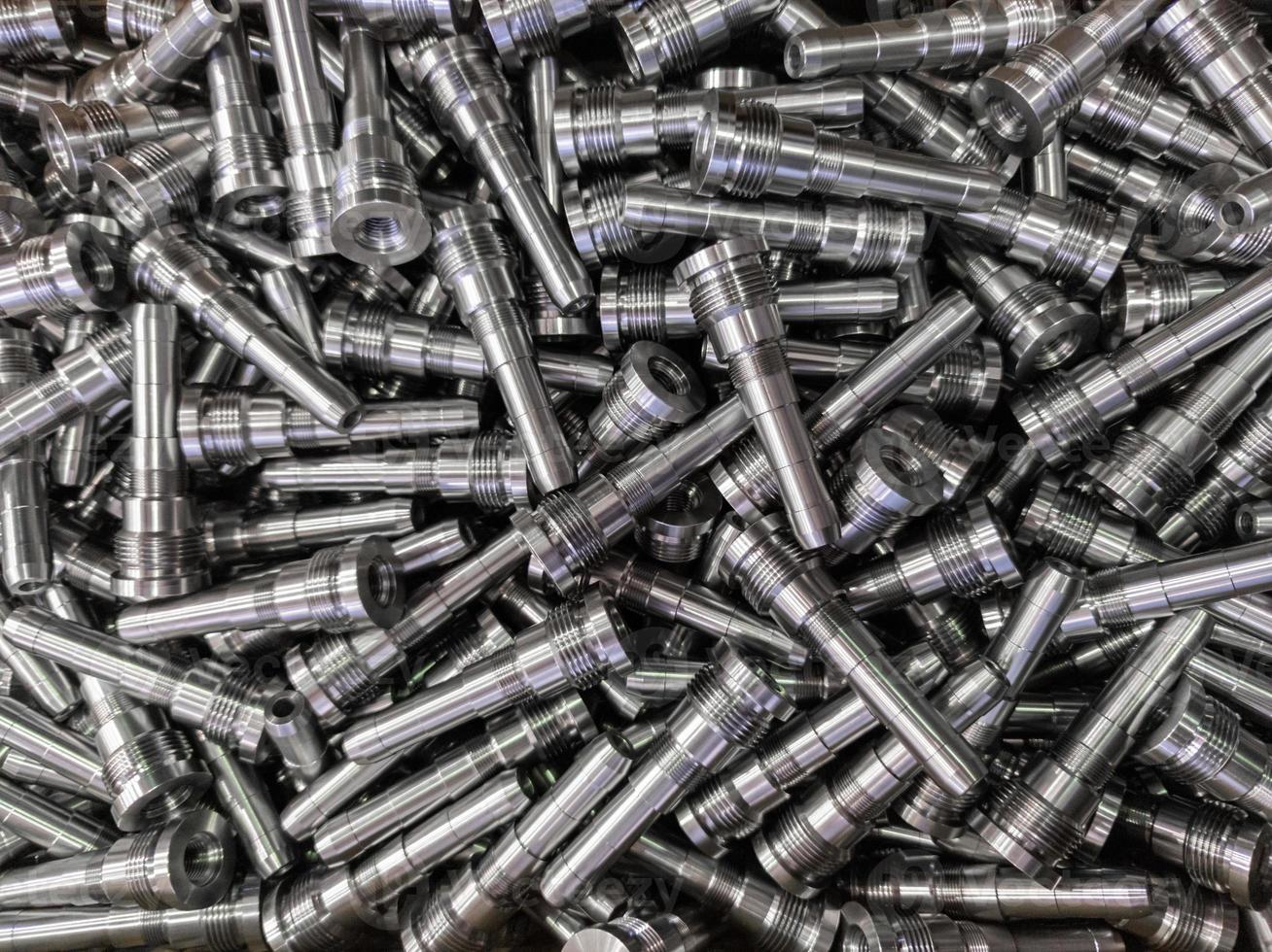 pile of shiny long steel parts, clean steel rods after fine cnc turning photo