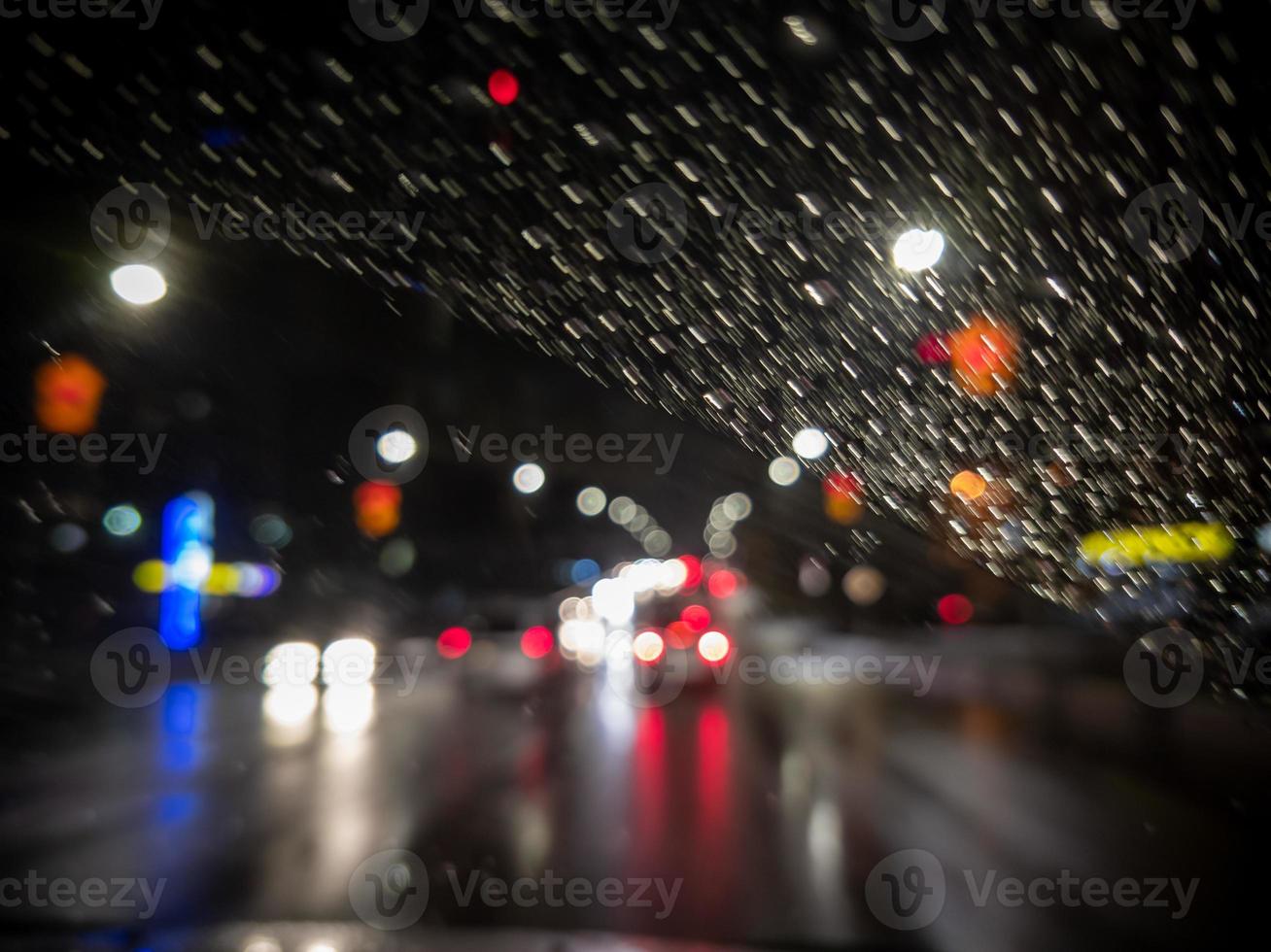 defocused photo of night driver view on city from right steering car