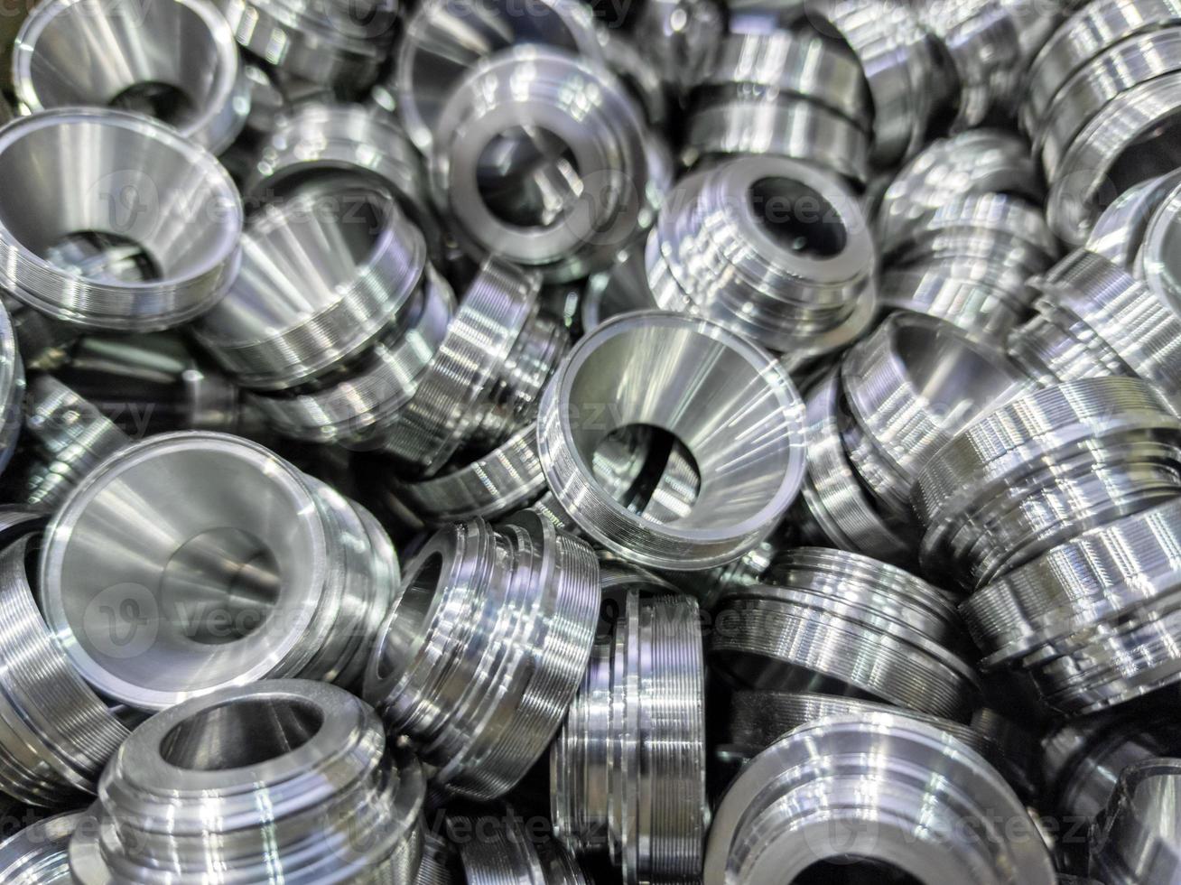 pile of shiny metal aerospace parts production - close-up with selective focus for full frame industrial background photo