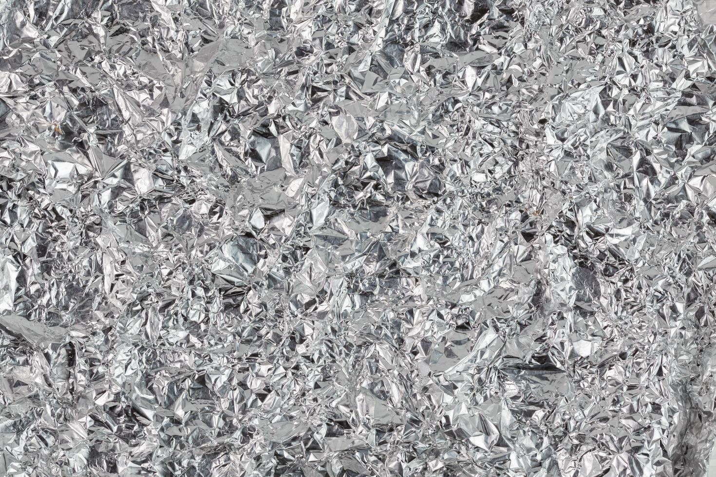crumpled aluminium foil flat background and texture photo