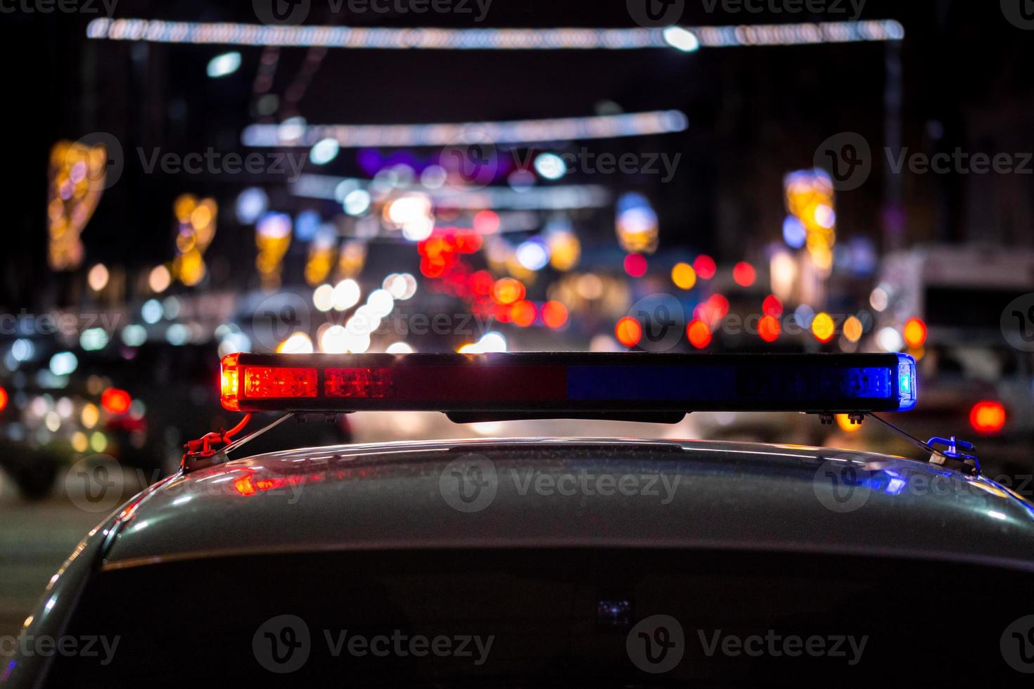 police car lights at night in city with selective focus and bokeh photo