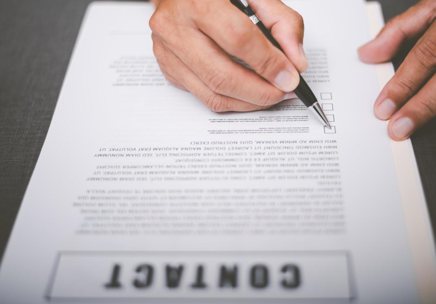 Business owner checking documents and reports and agreements To consider the approval of the business contract, before signing the signature, employment idea, project review, work from home. photo