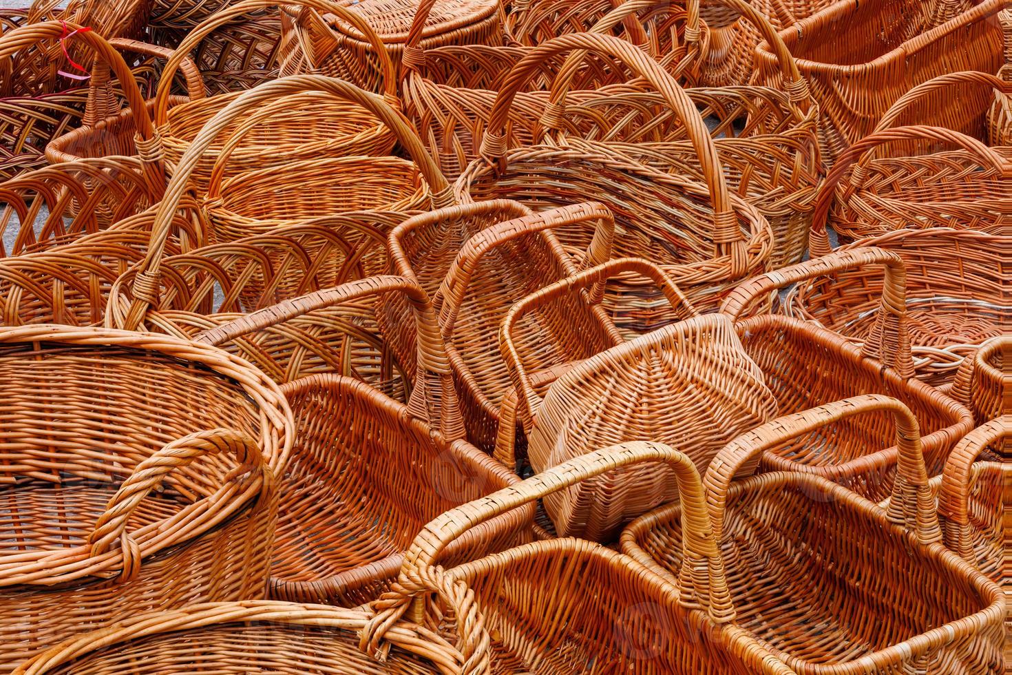 A lot of of many wicker baskets for sale - closeup full-frame background photo