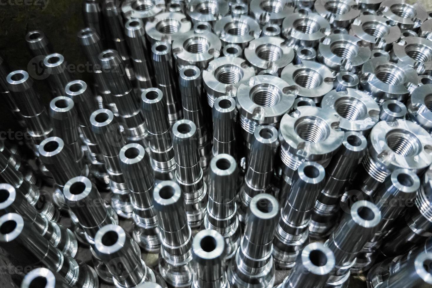 Shiny steel parts close-up background, long clean steel rods after fine cnc turning photo