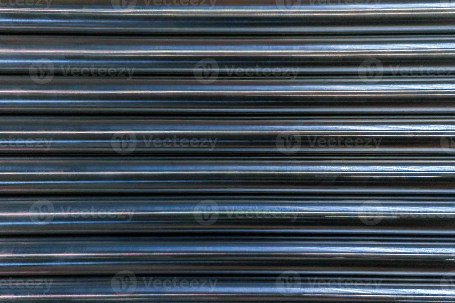 abstract industrial background of shiny cnc turned rods with flat lay horizontal parallel geometric pattern photo