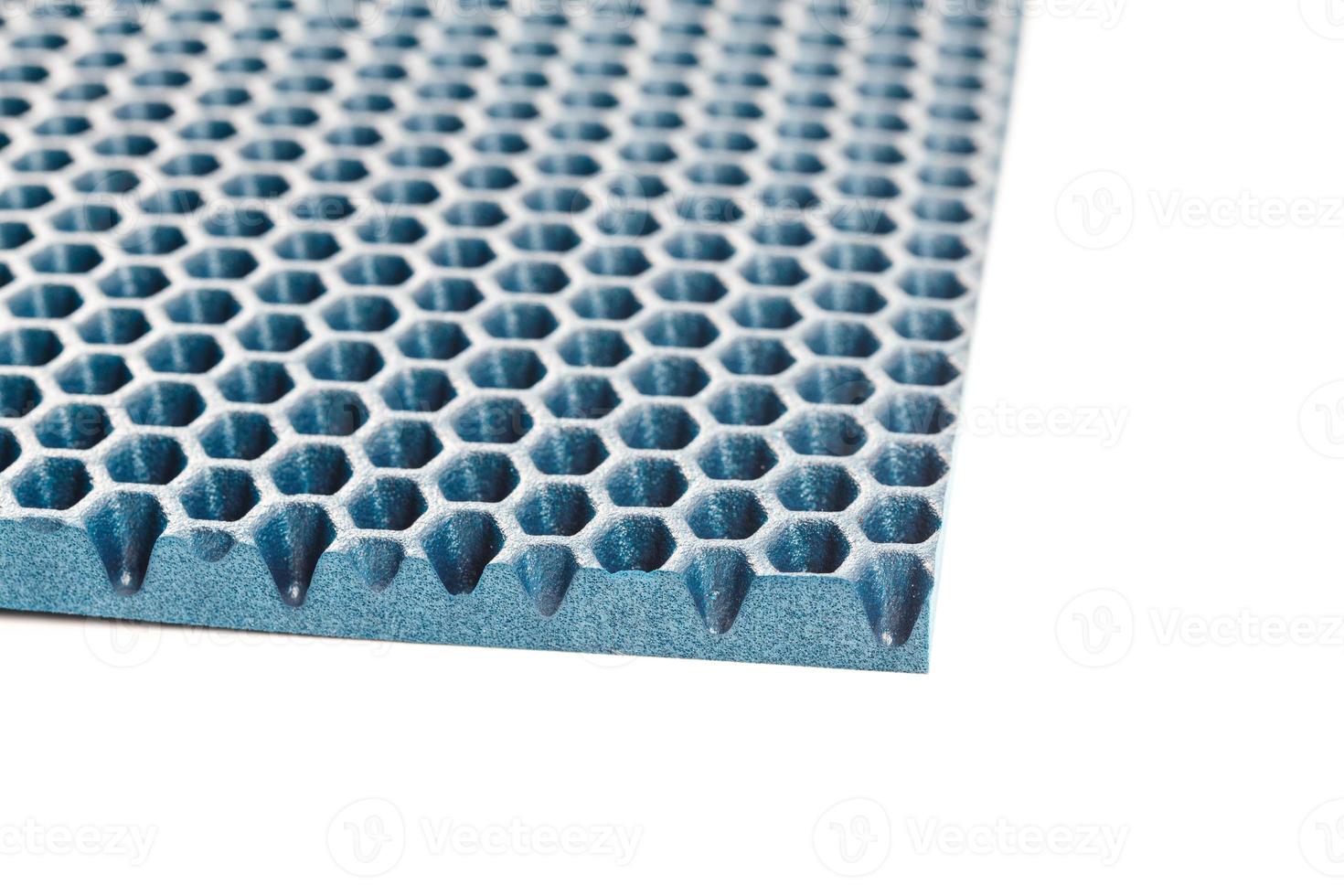 blue hexagonal punched EVA - ethylene vinyl acetate foam carpet linear perspective background with selective focus photo