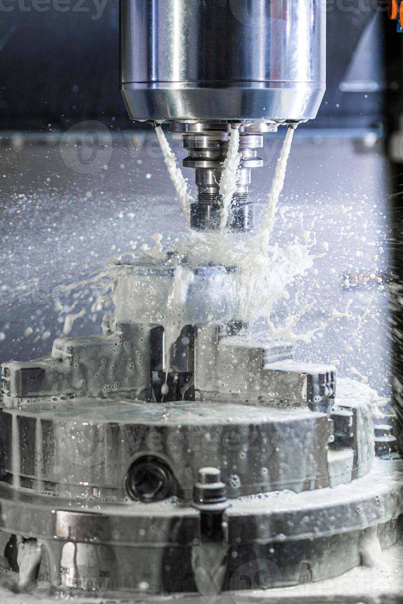 Vertical photo of industrial wet milling process in 5axis cnc machine