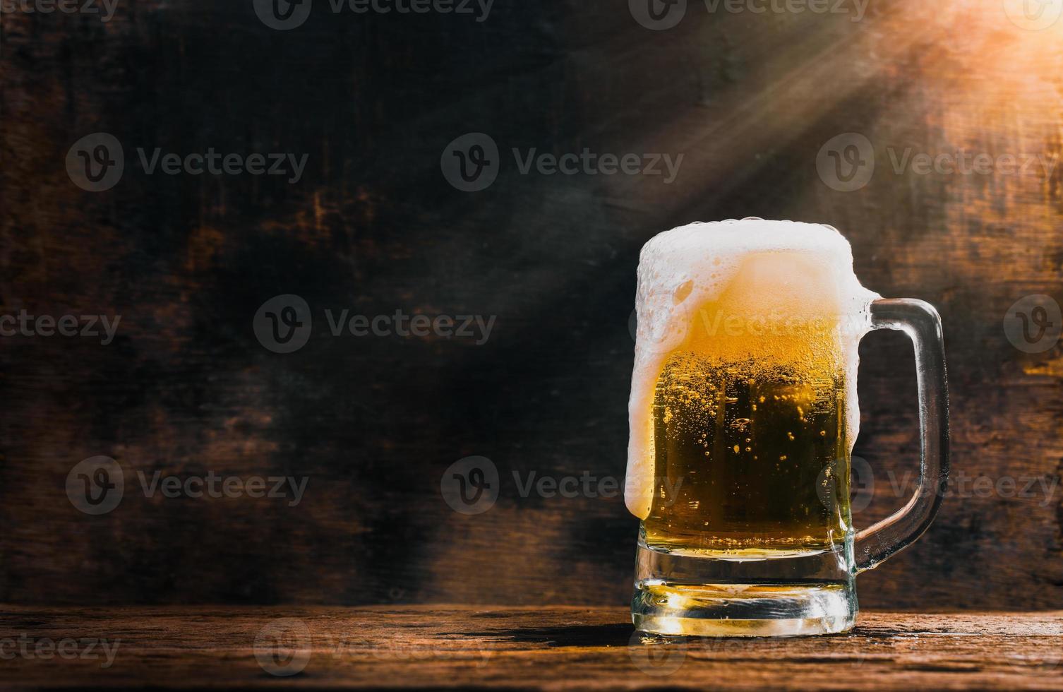 Glass beer on wood background photo