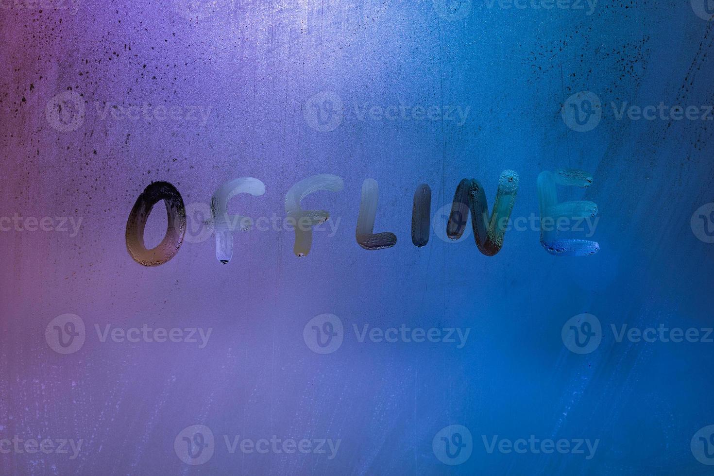 word offline handwrittern on foggy glass with cold neon blue back light photo