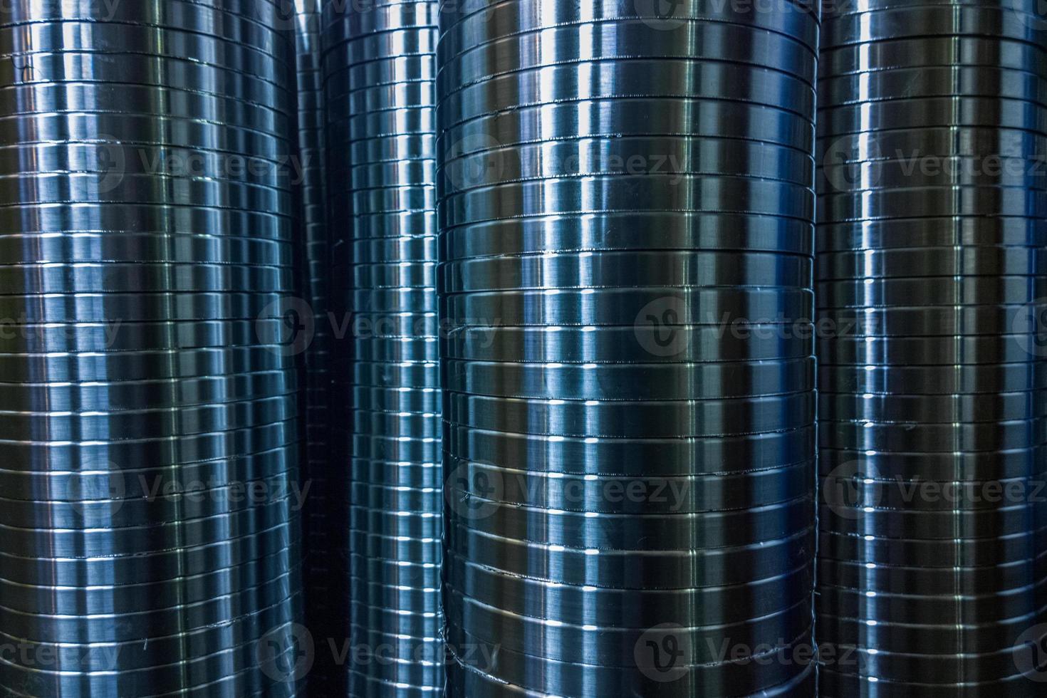 industrial manufacturing background of columns of shiny metal rings after cnc turning operation photo