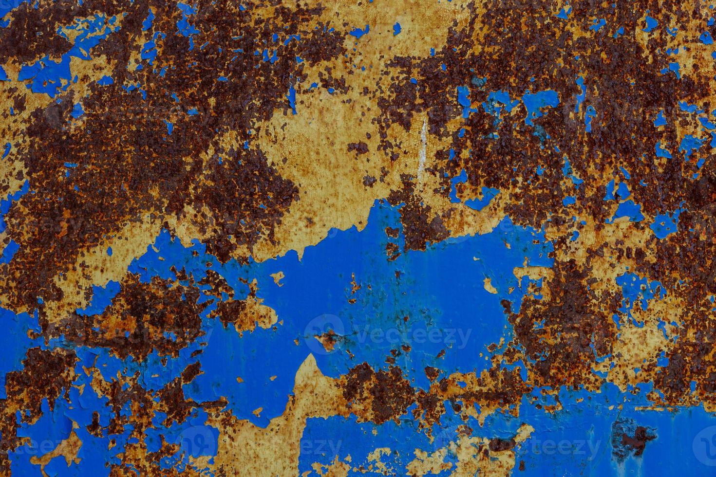 flat texture of rusted steel sheet with two peeled off layers of paint - yellow and blue photo