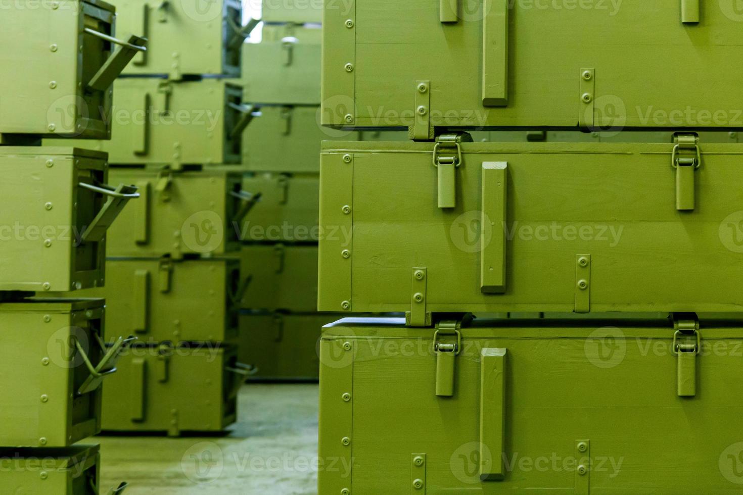 stacks of abstract green military crates without any markings - close-up with selective focus and background blur photo