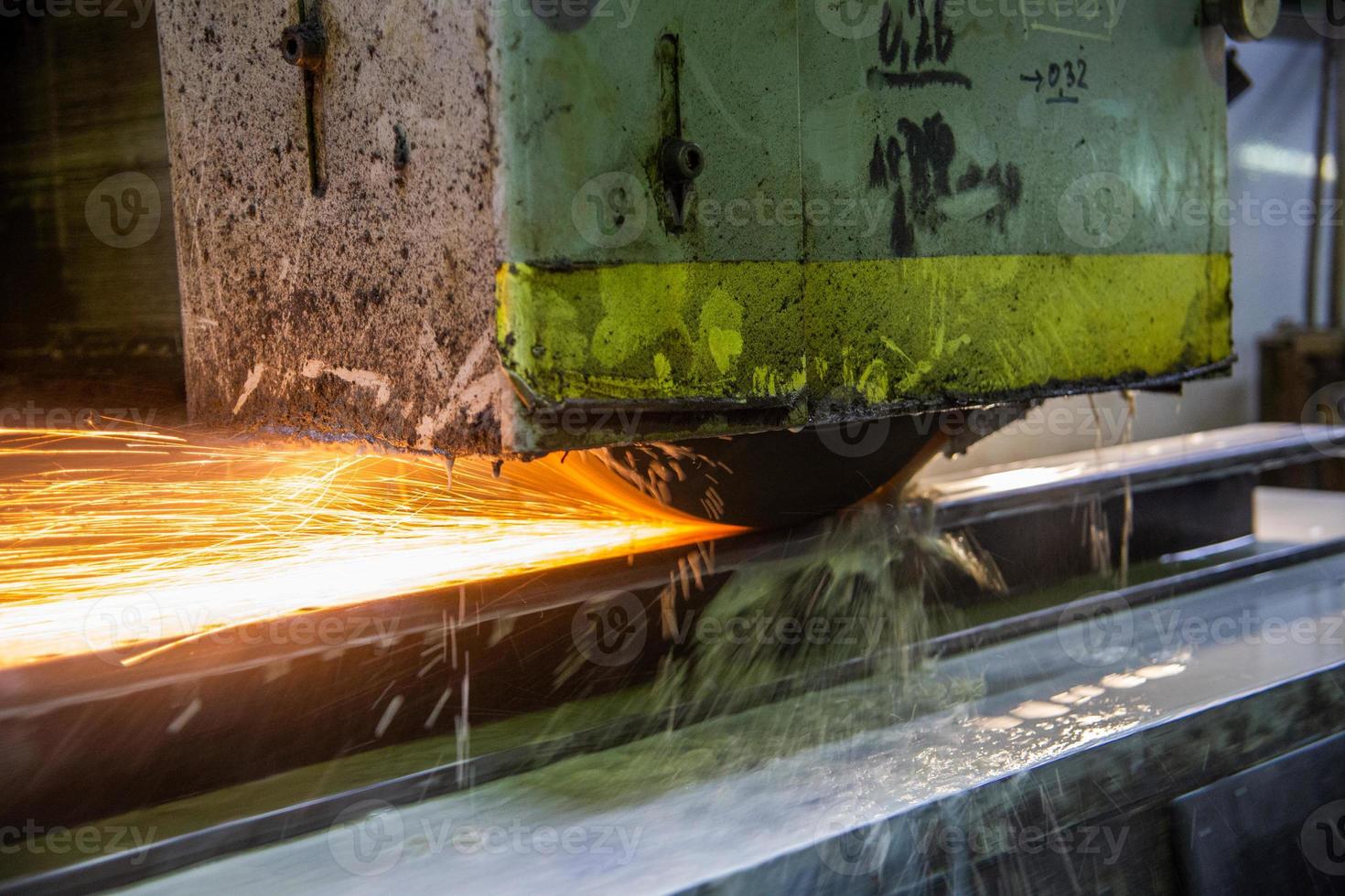 a process of flat surface grinding with a lot of sparks and liquid