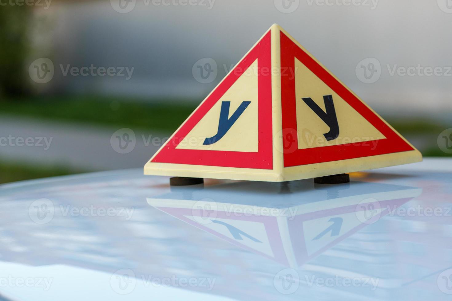 Standard triangle piramid sign of a russian driving school on top of the vehicle. photo
