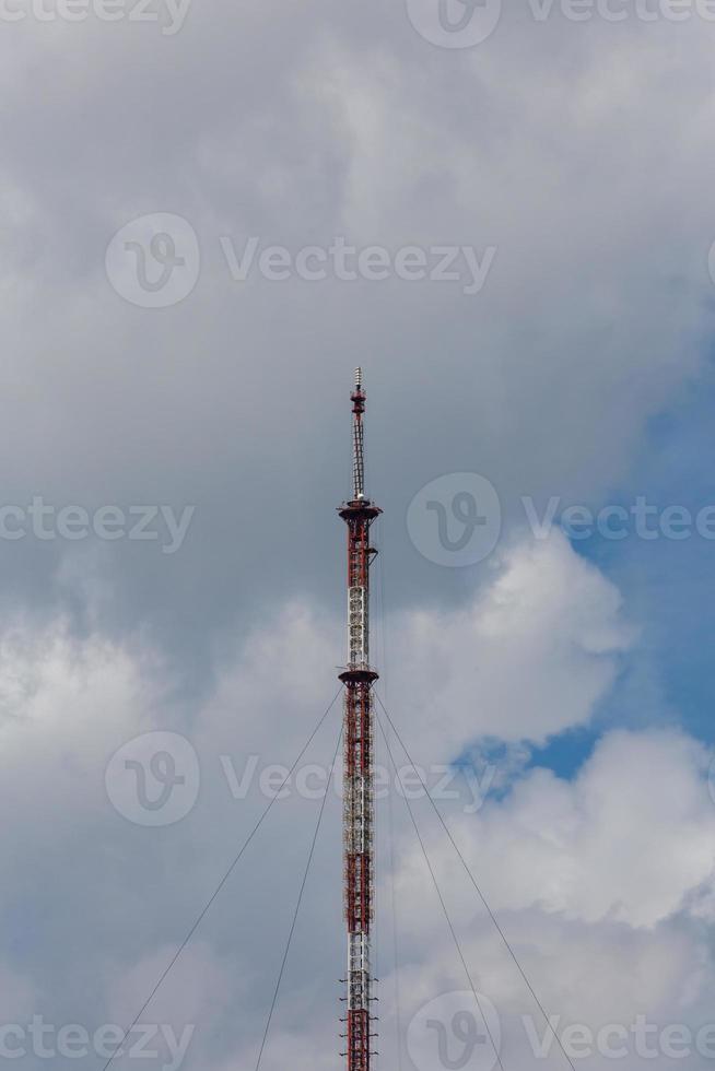tall metal frame television tower on cloudy sky daylight background photo
