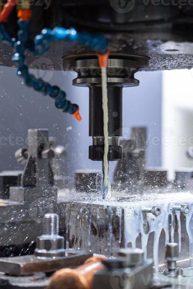 a process of cnc vertical drilling with liquid coolant flow photo