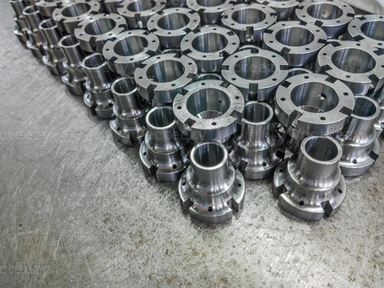 Shiny steel parts after cnc turning and milling, industrial background photo