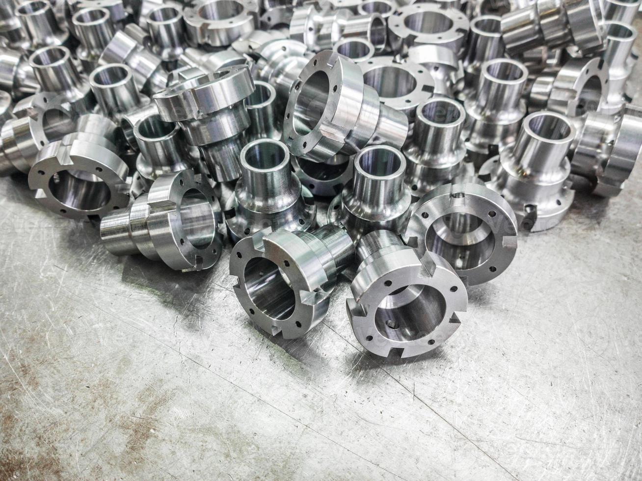 Shiny steel parts after cnc turning, drilling and machining on steel surface photo