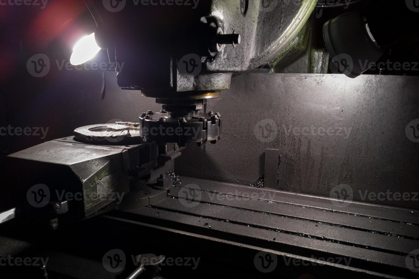 old manual milling machine in noir lighting style closeup with selective focus photo