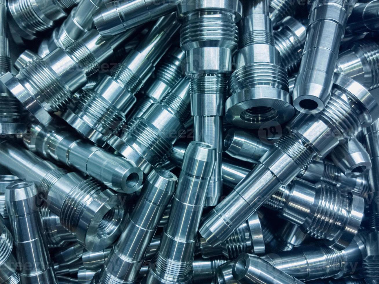 shiny steel parts background, a pile of long steel rods after modern cnc turning photo