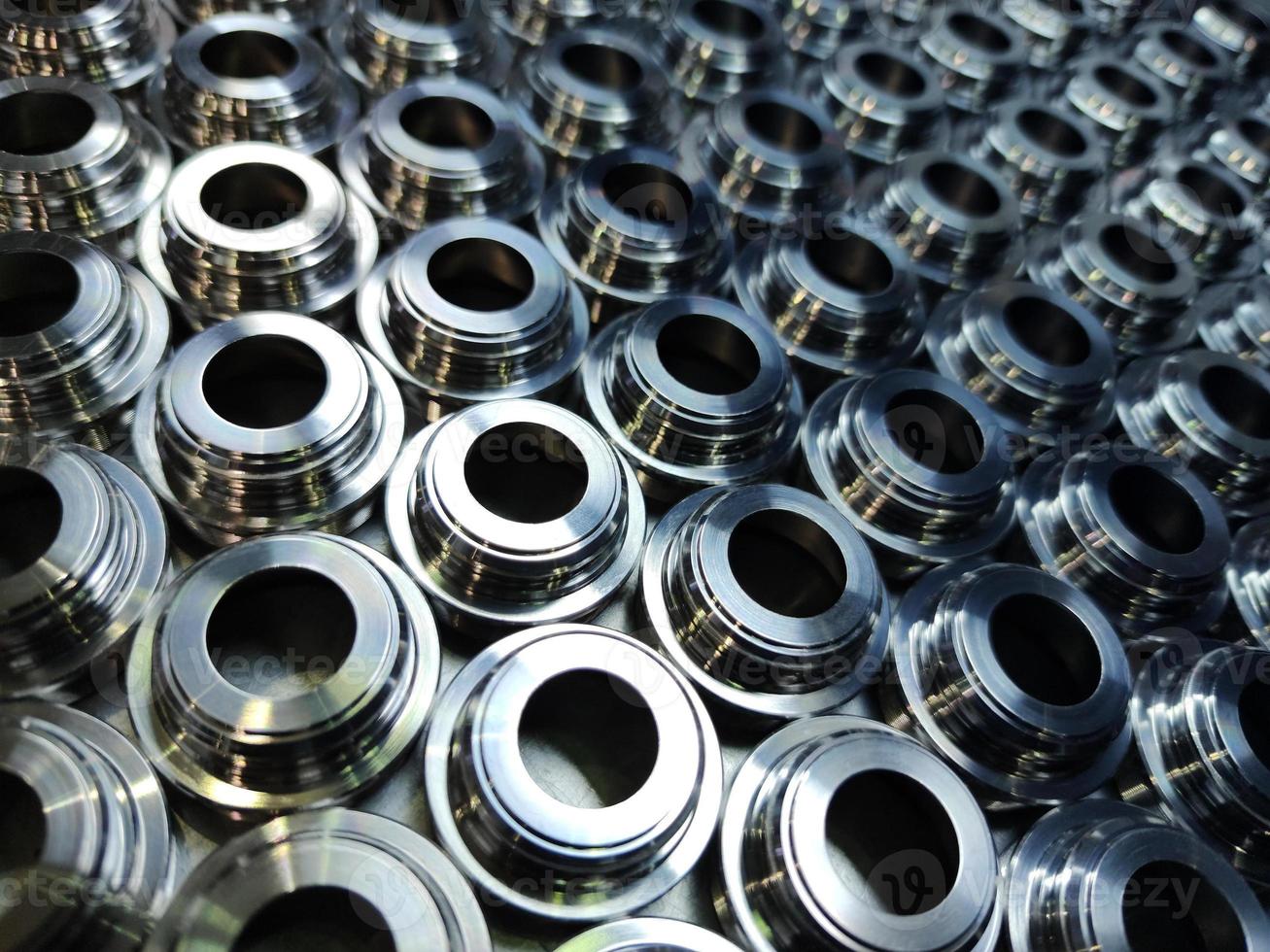 Shiny steel parts background. Regular industrial metal production pattern with selective focus. photo