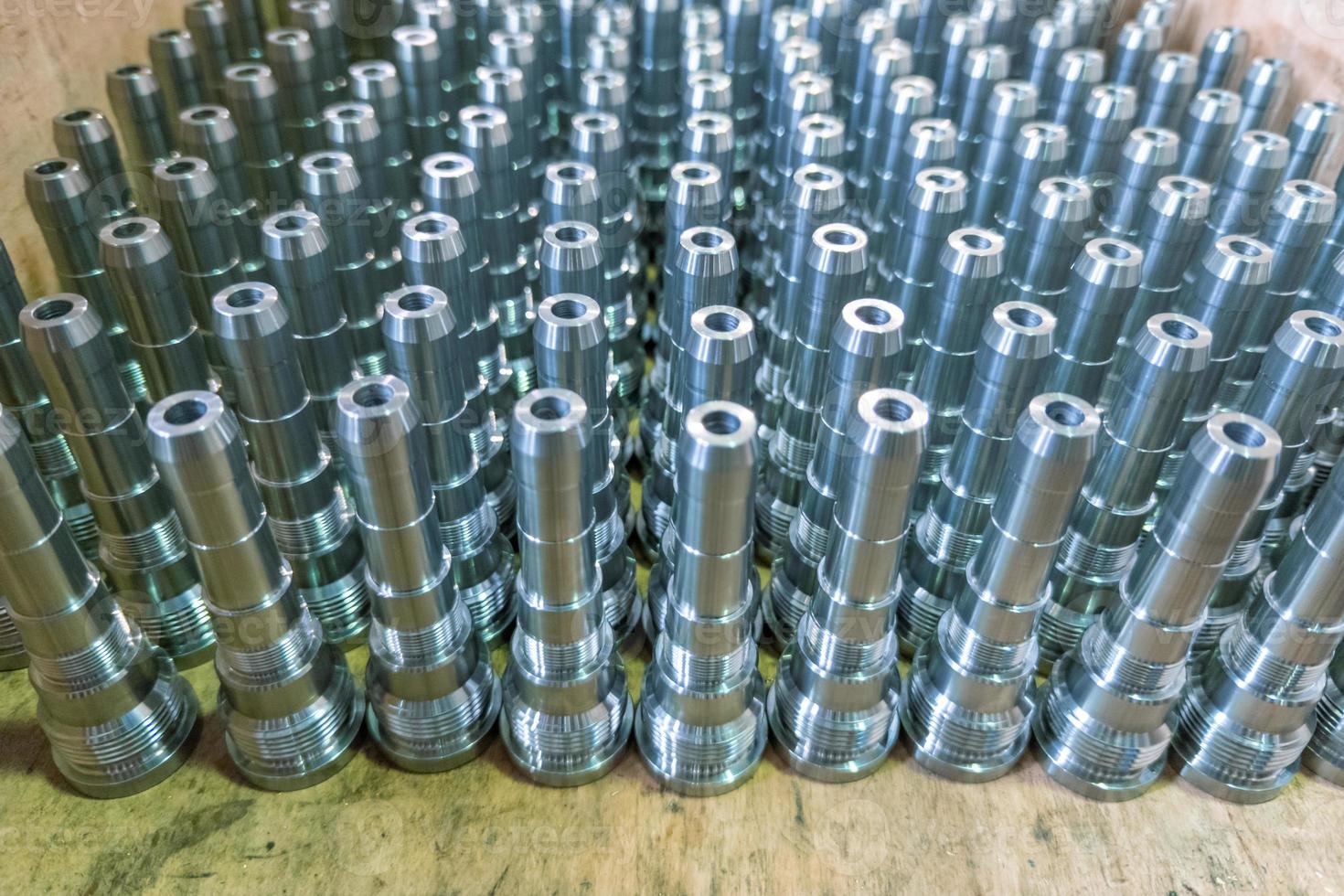 Shiny long steel parts background, clean steel rods after fine cnc turning. photo