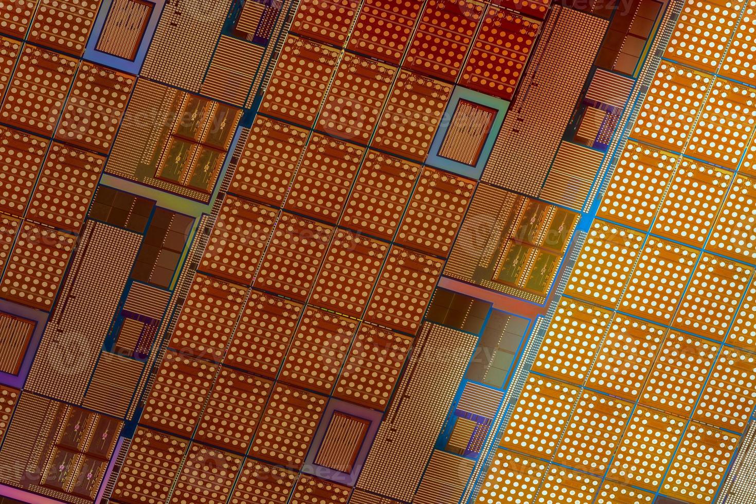 Silicon wafer with microchips used in electronics for the fabrication of integrated circuits. Full-frame high-tech macro background. photo