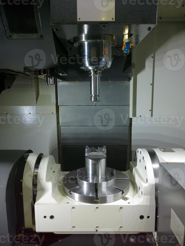 The five-axis Computer Numerical Control CNC machine waiting for stock change photo