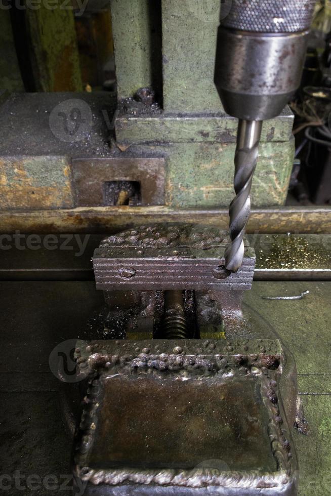 old drilling machine with obsolete used vice with selective focus photo