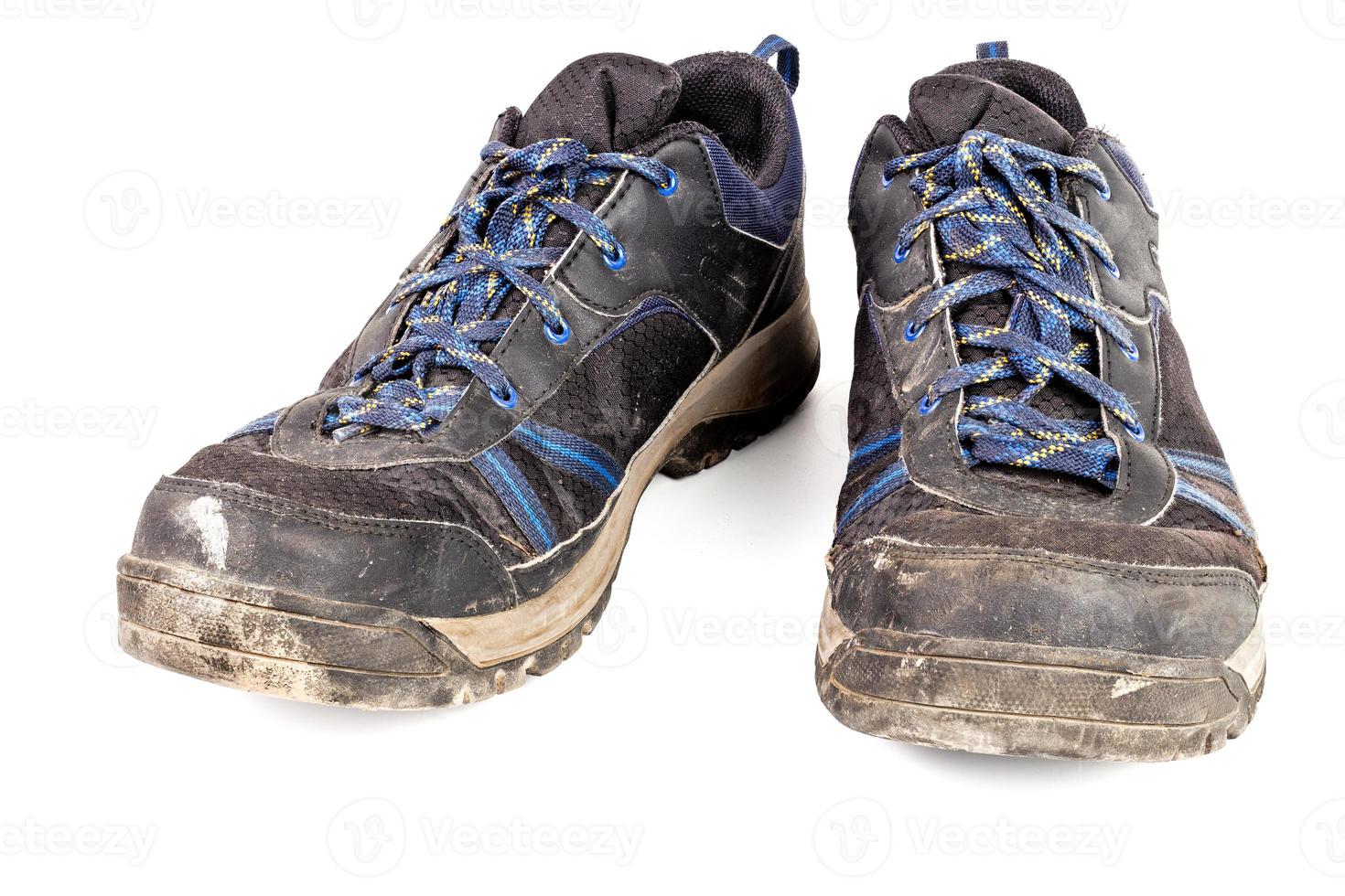 dirty used worn out black outdoor sneakers isolated on white photo