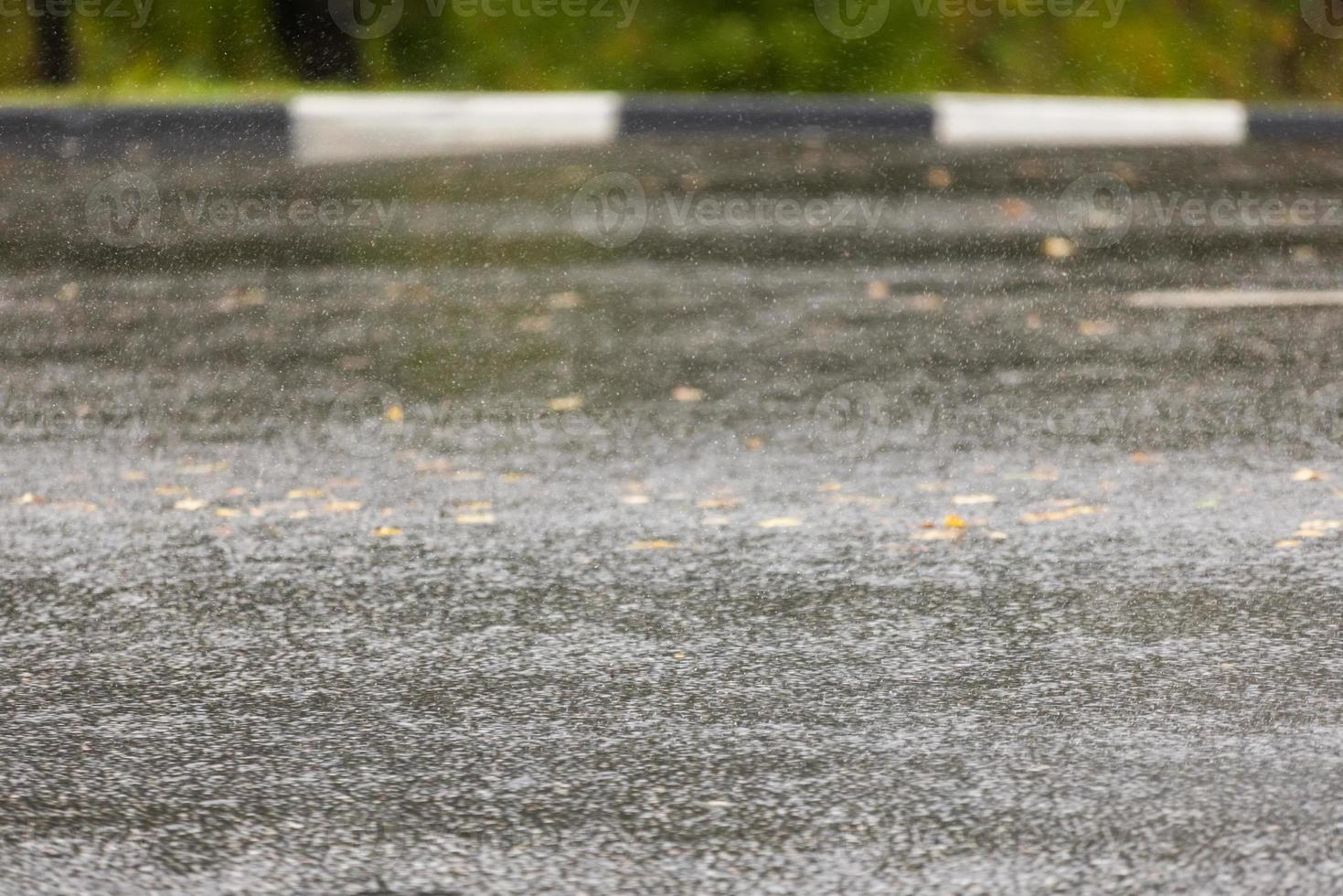 asphalt road under rainfall or drizzle with fast shutter speed photo