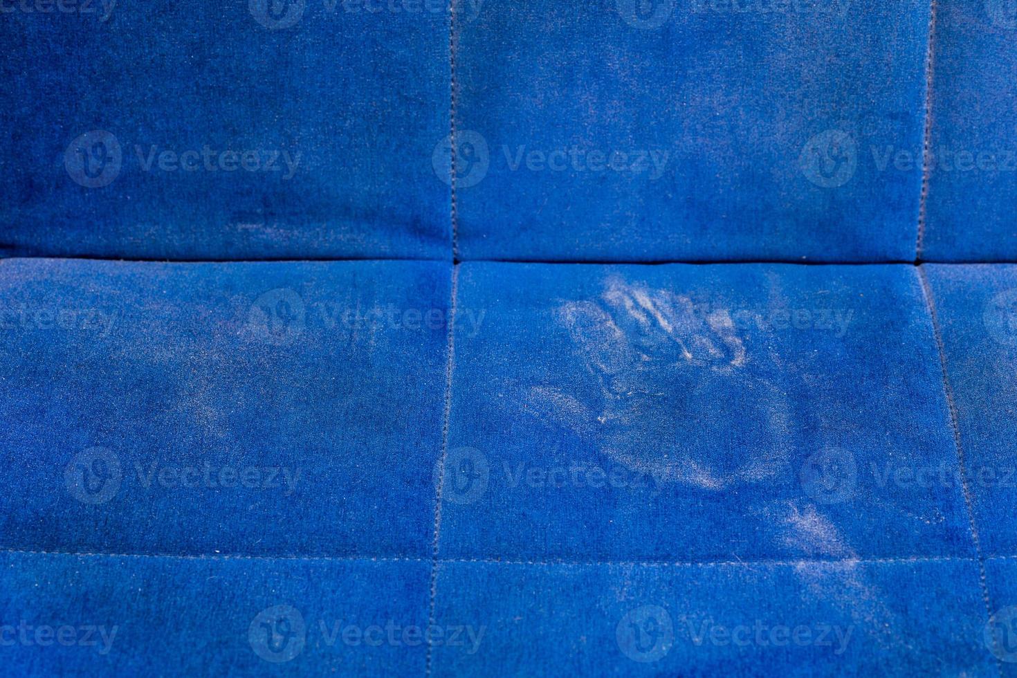dusty blue sofa surface with palm prints closeup with selective focus photo