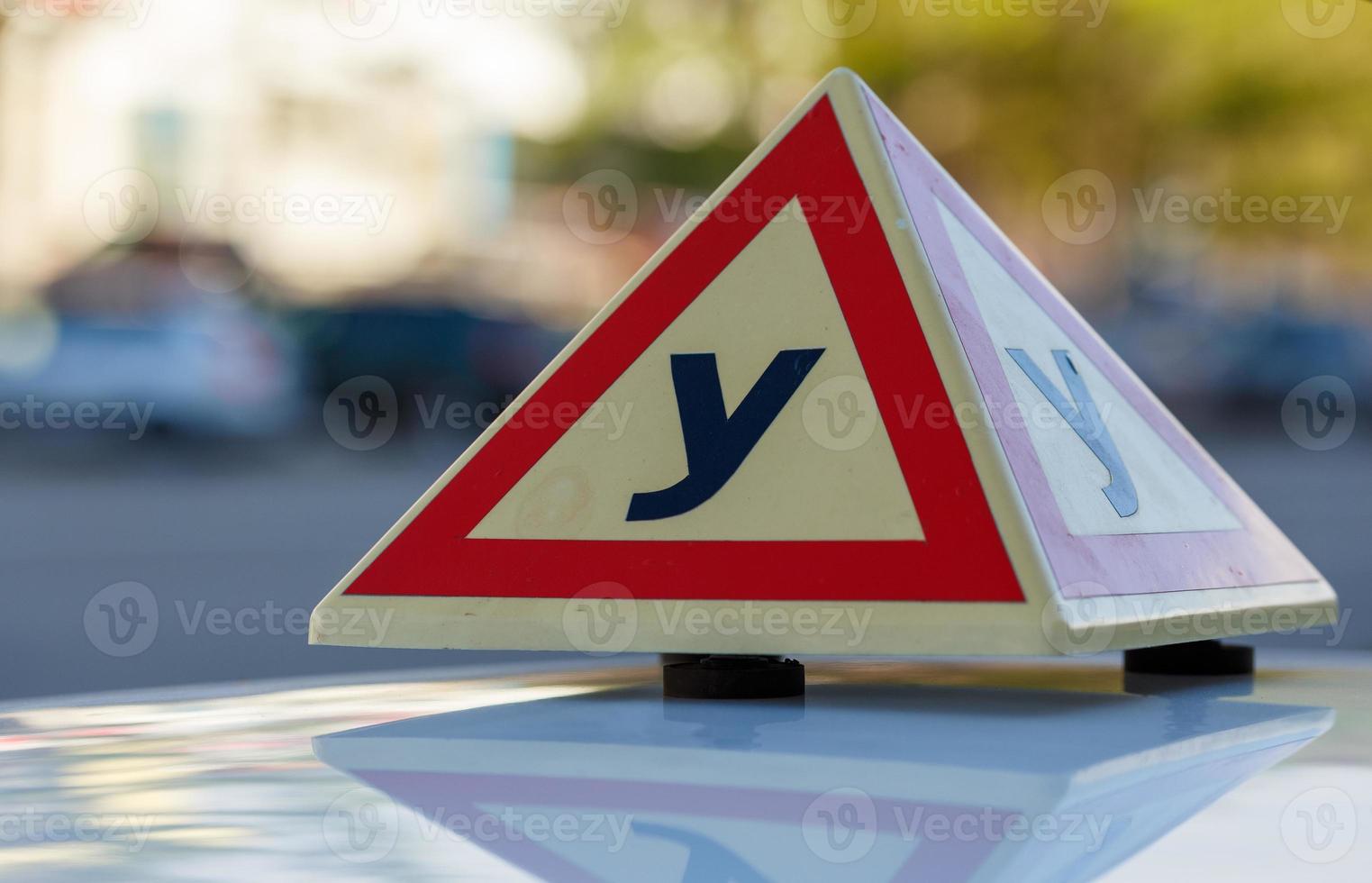 Standard triangle piramid sign of a russian driving school on top of the vehicle. photo
