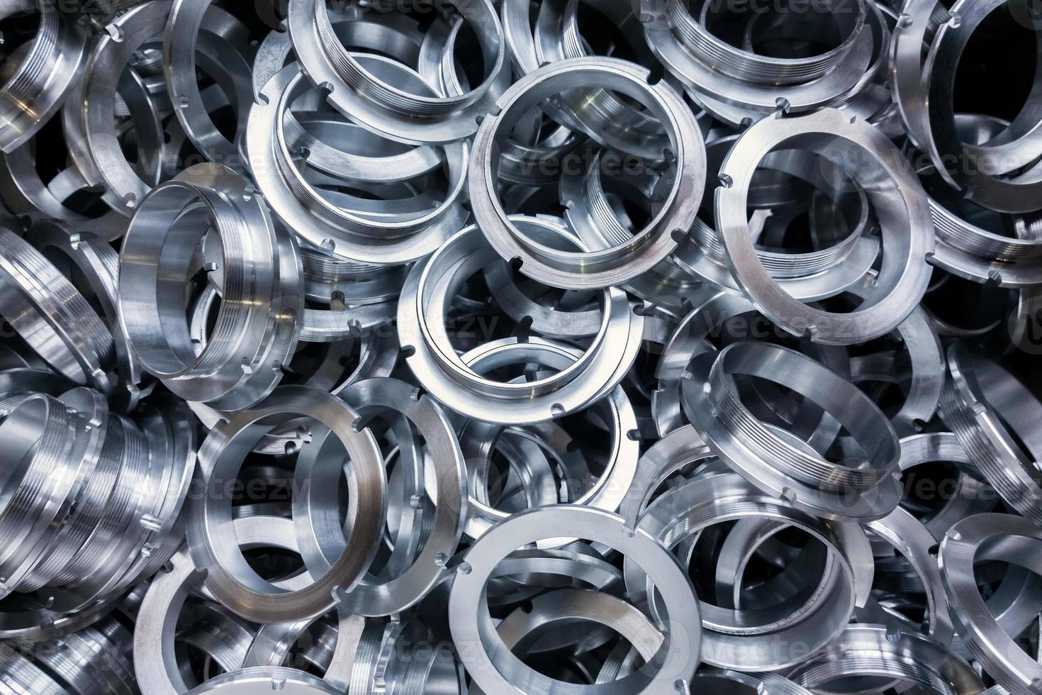 a batch of machined shiny metal parts with selective focus photo