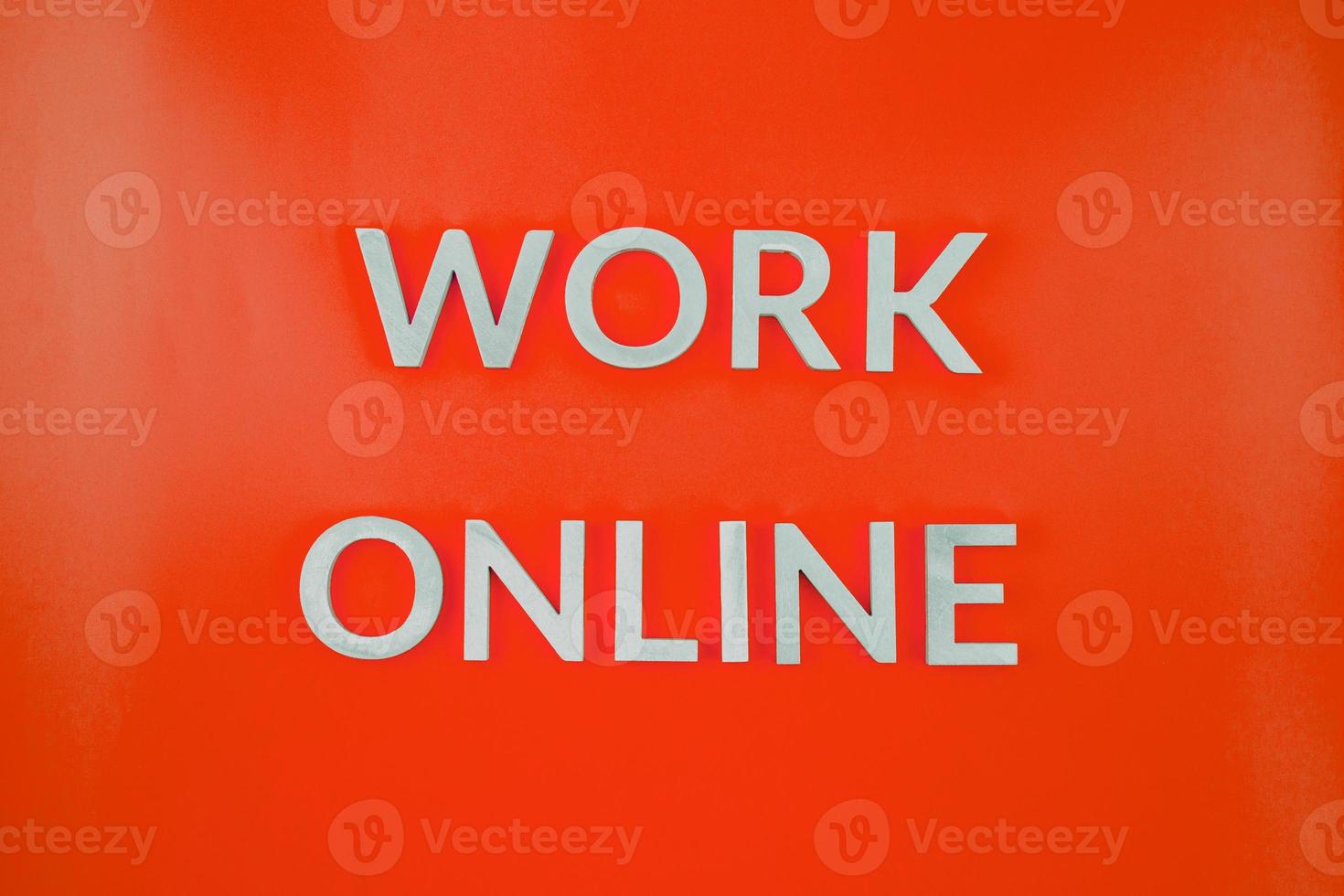 the words work online laid with brushed aluminium letters on red flat surface - close-up with flat lay composition photo