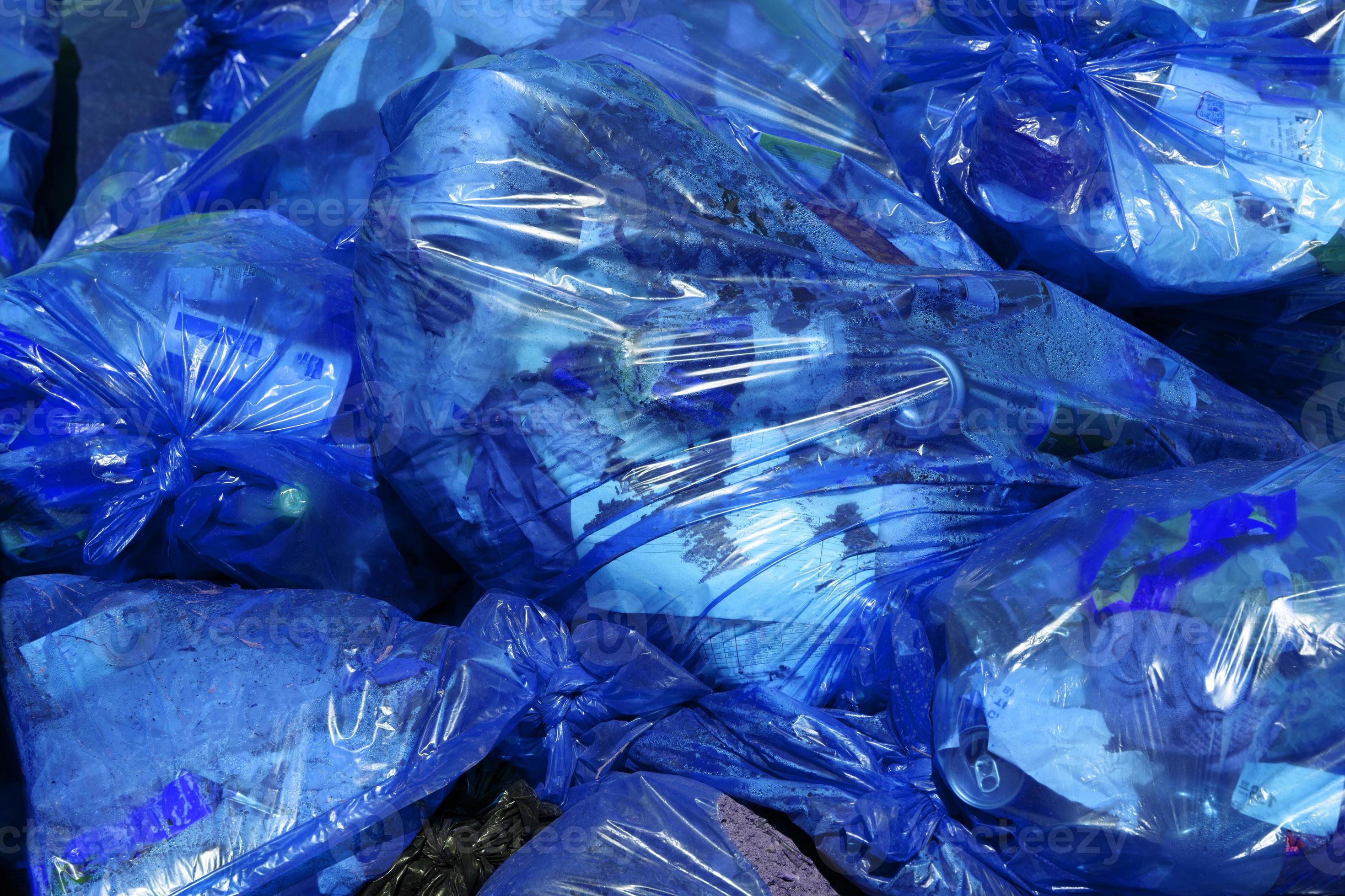 full frame background of blue plastic trash bags with generic domestic