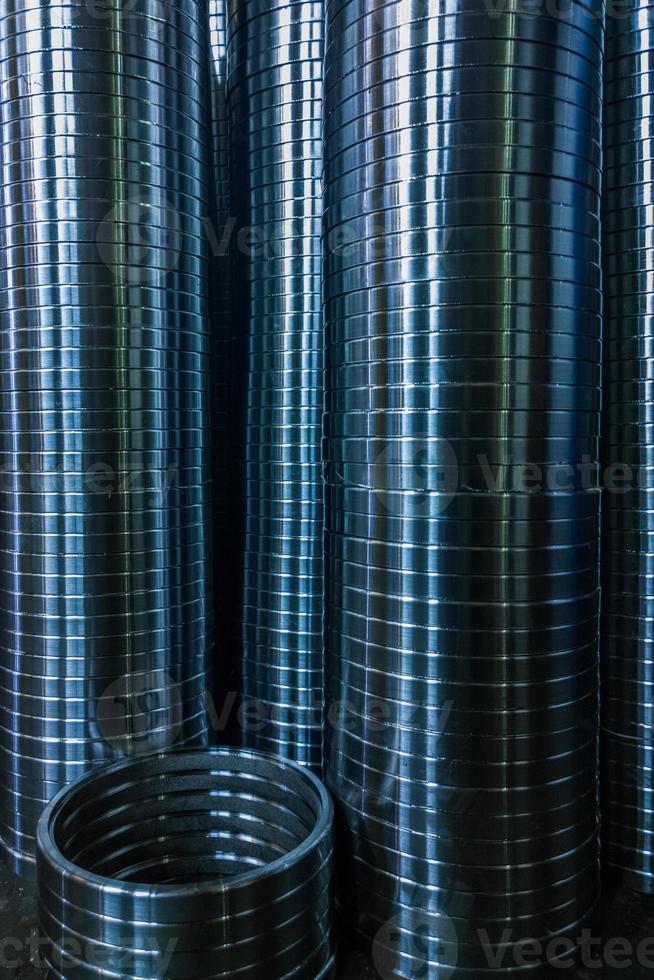industrial manufacturing background of columns of shiny metal rings after cnc turning operation photo