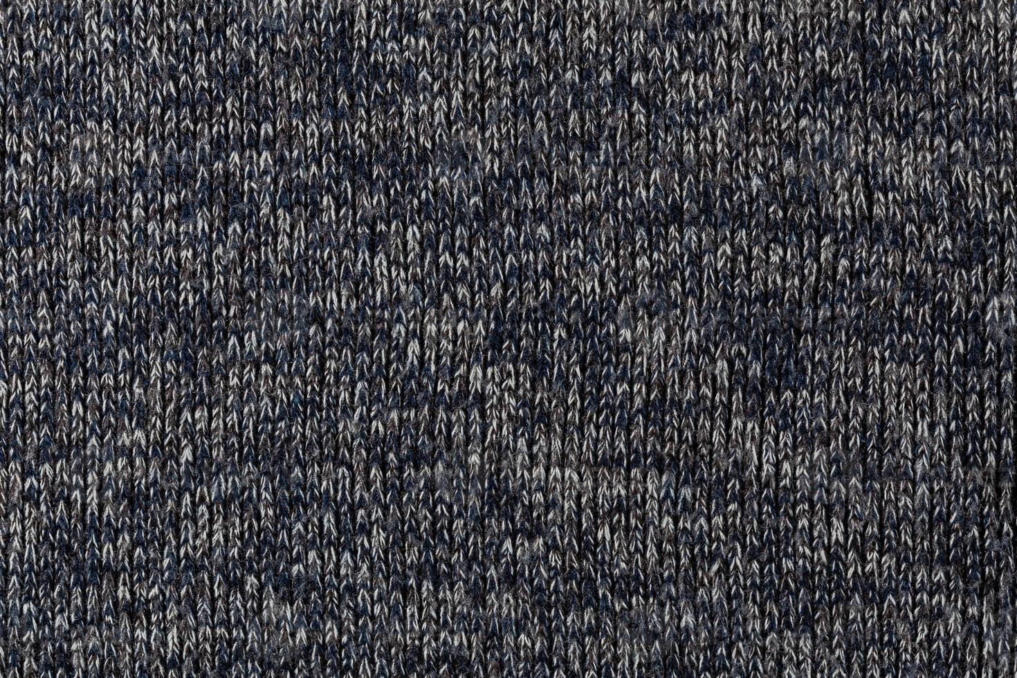 macro photo of warm gray melange polyester sweater with even vertical structure