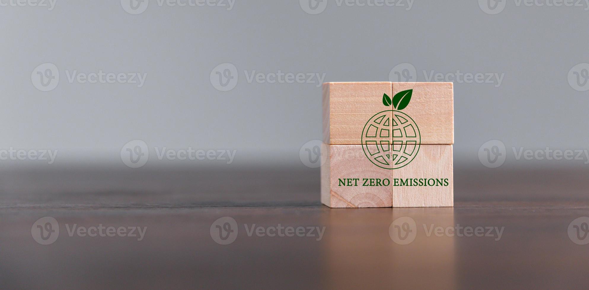 Companies are targeting net zero greenhouse gas emissions. Carbon credit concept.Tradable certificate to drive industry in direction of low emissions in efficiency cost. Wooden cubes with decrease CO2 photo