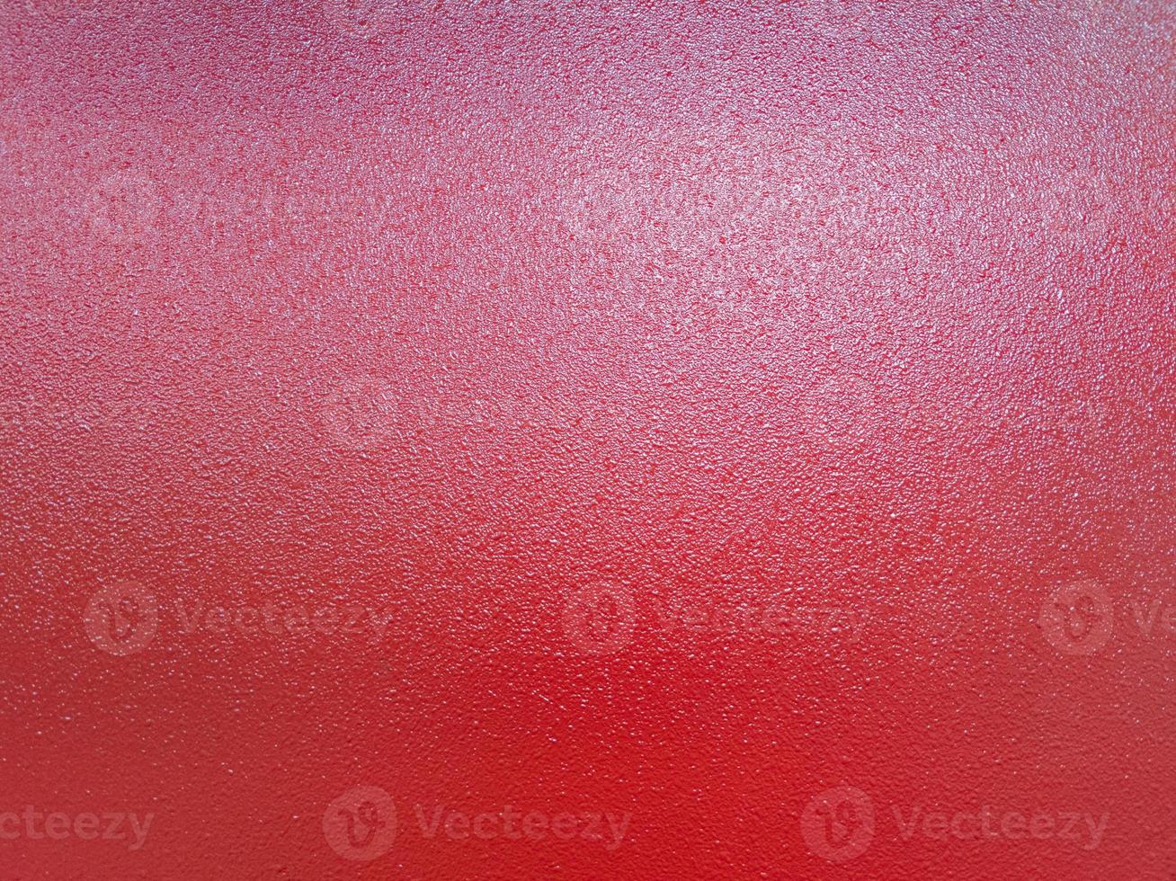 background of red shagreen powder paint coating on flat sheet steel surface photo