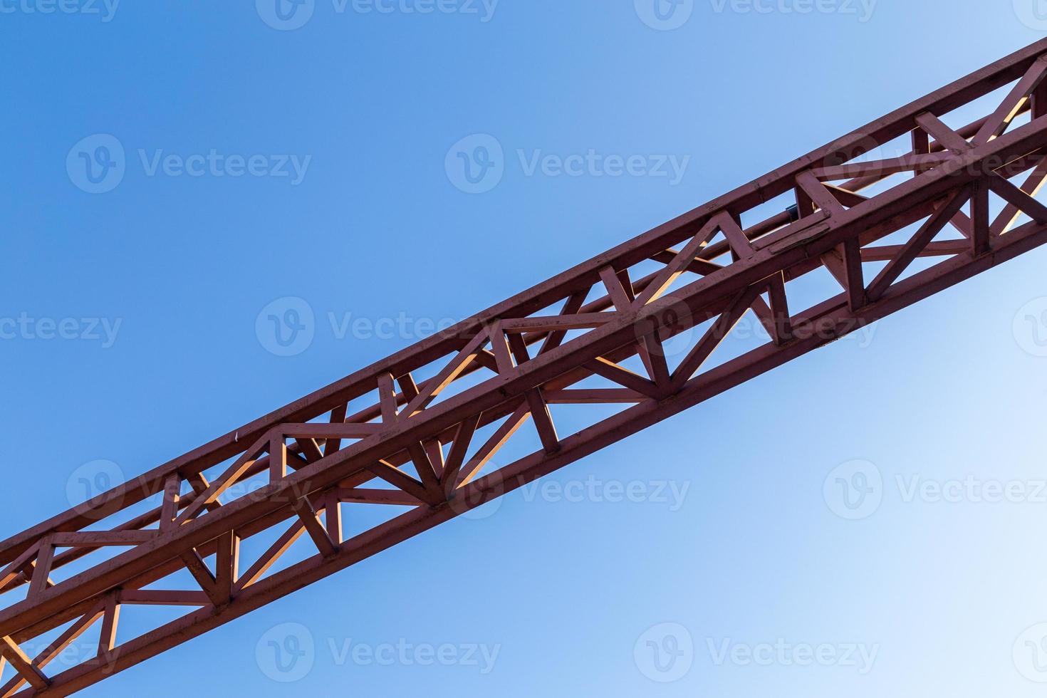 straight red steel welded truss on blue sky background photo