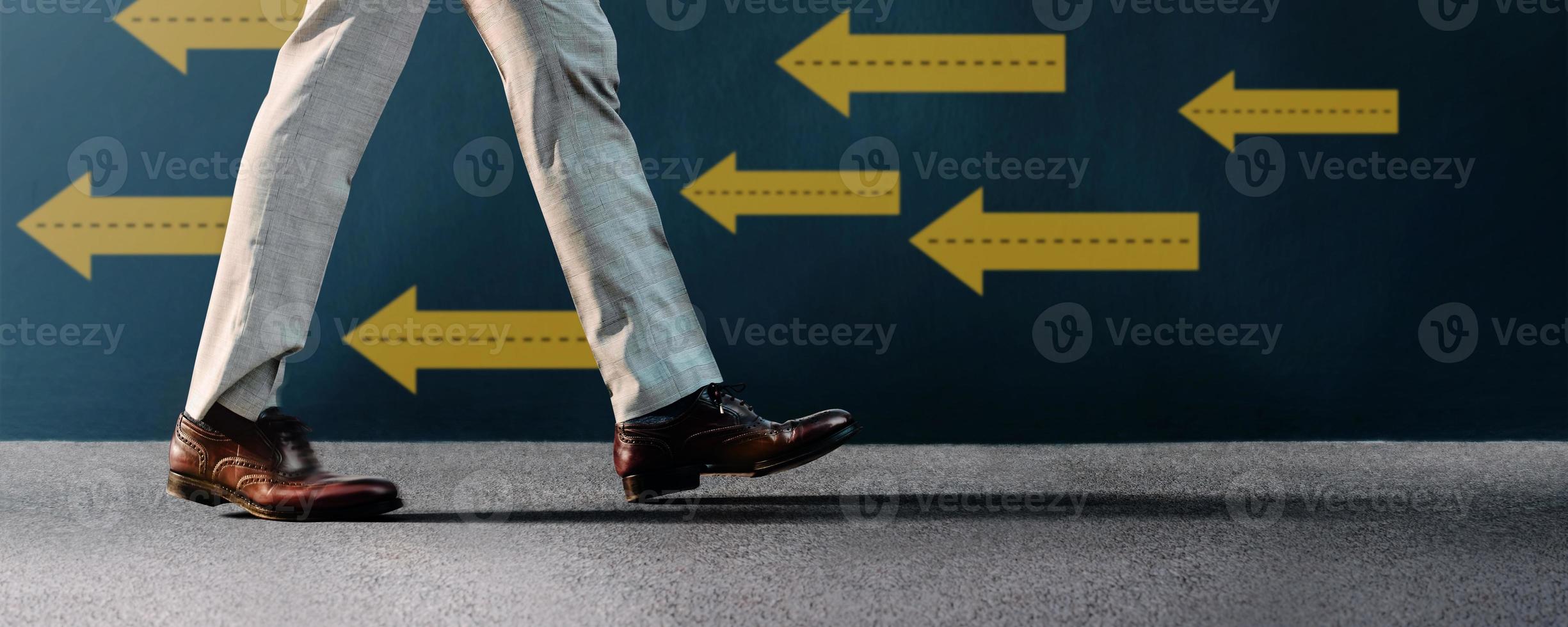 Think and Make the Different Concept. Unique Leadership. Businessman Walking Conversely the Arrow Direction. Different from Others. Low Angle View photo