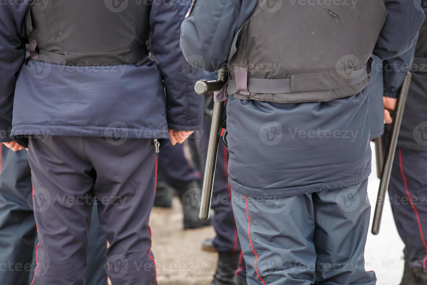 russian police officer with black rubber tonfa baton hanging on his belt photo