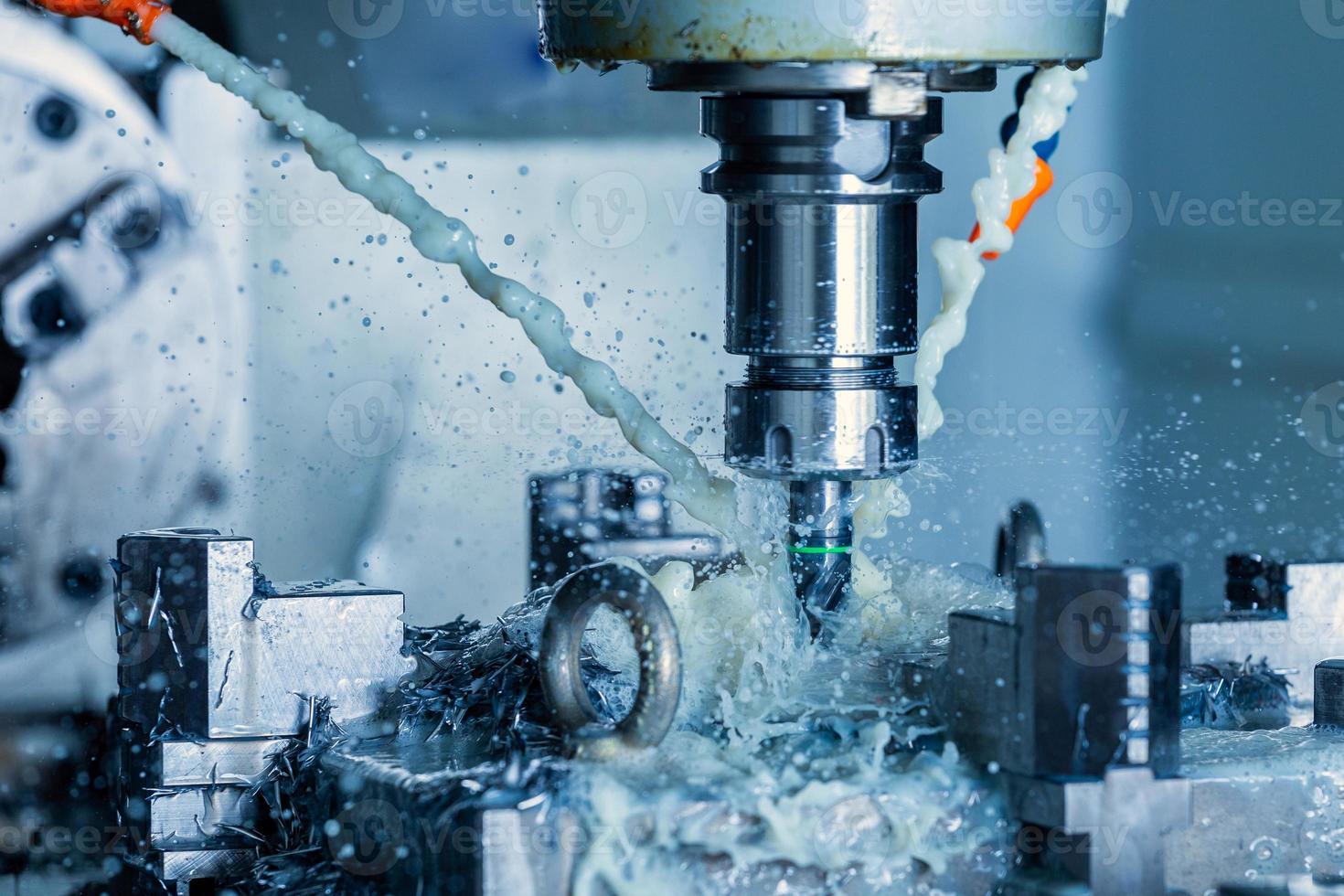 vertical cnc steel milling process with external water coolant streams, splashes and a lot of metal chips, high contrast photo