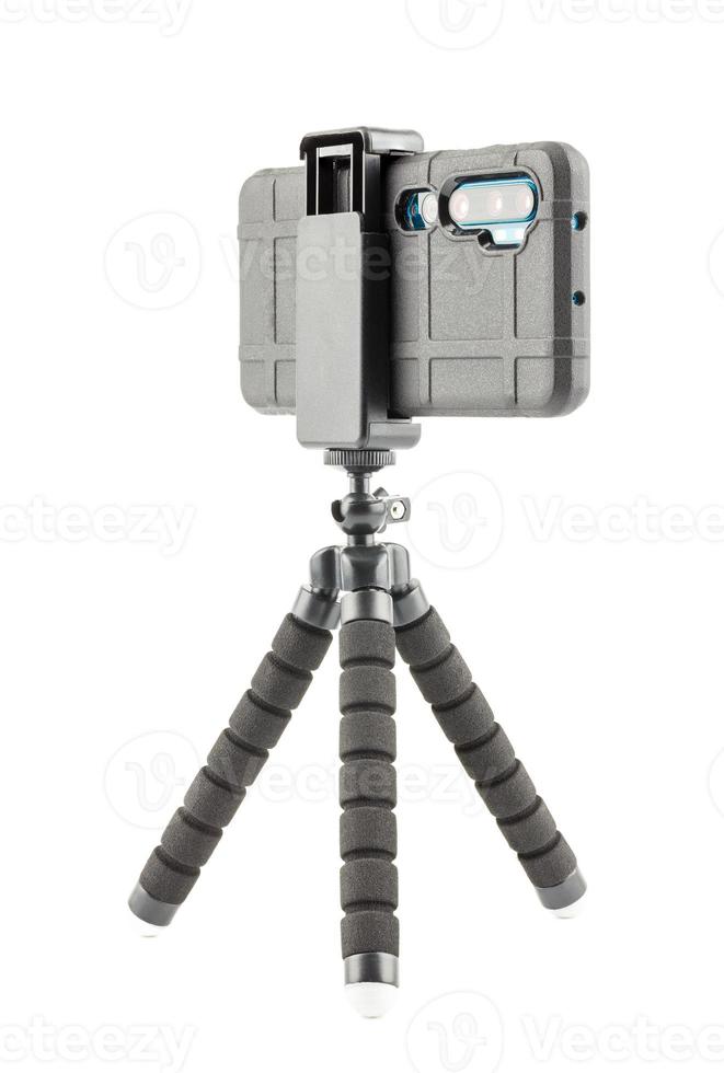 black cellphone in rugged rubber protective cover on small flexible tripod isolated on white photo