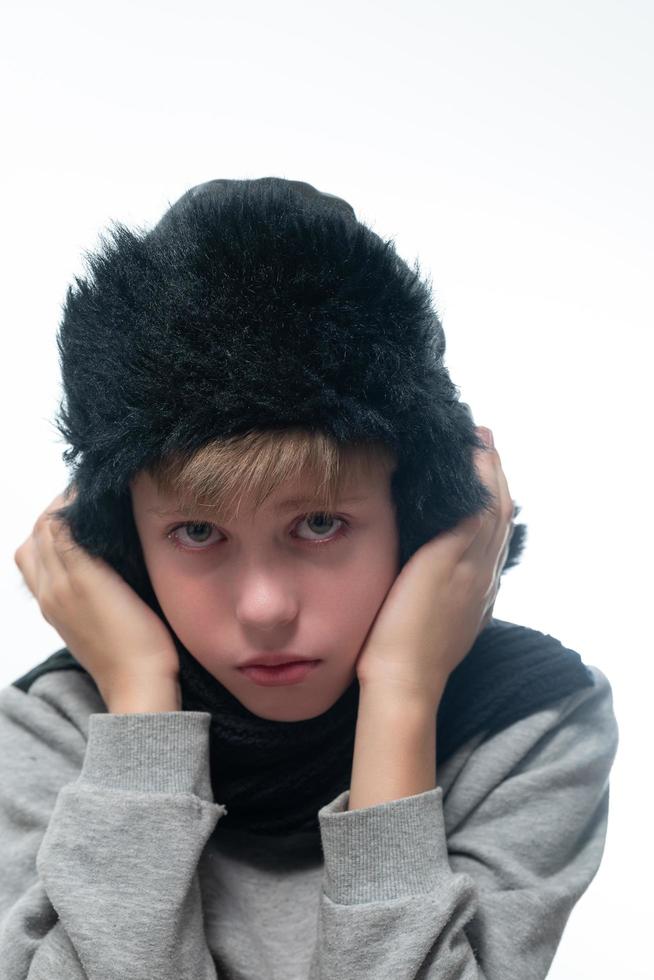 retrato de un tipo molesto con sombrero y bufanda de invierno, invierno frío y tiempo de crisis. foto